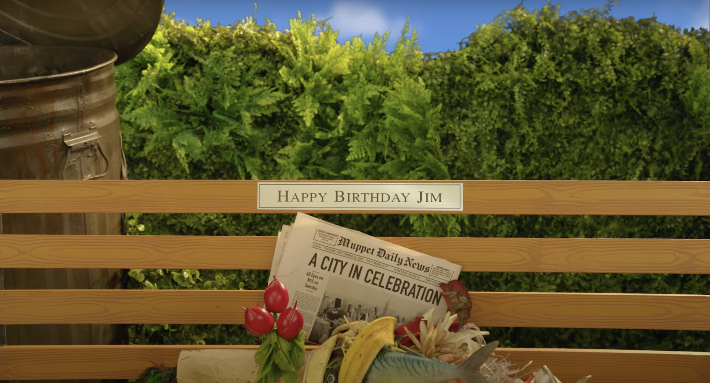 The image shows a wooden park bench with a sign reading 